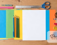 Chart paper decoration supplies flat lay with colored paper, pens and scissors