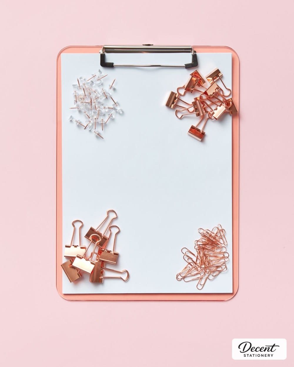 A clipboard with binder clips and pins arranged in the corners