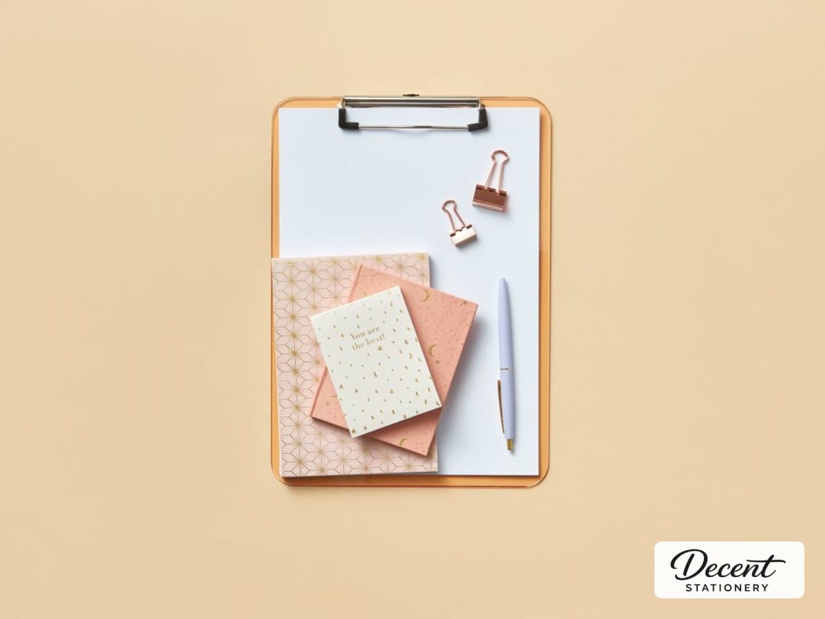 A clipboard styled with notebooks and a pen