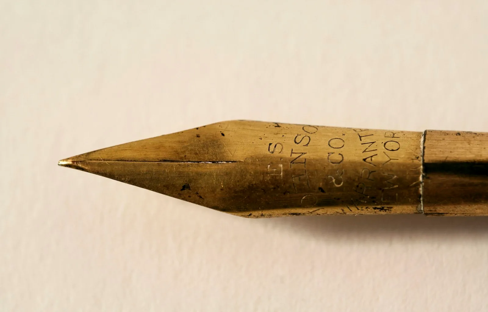 Close-up of a gold fountain pen nib, the part you submerge when you fill ink in a fountain pen
